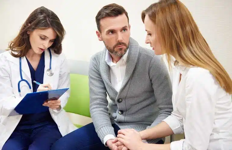 Canadian intended parents discussing donor wait times with a clinic